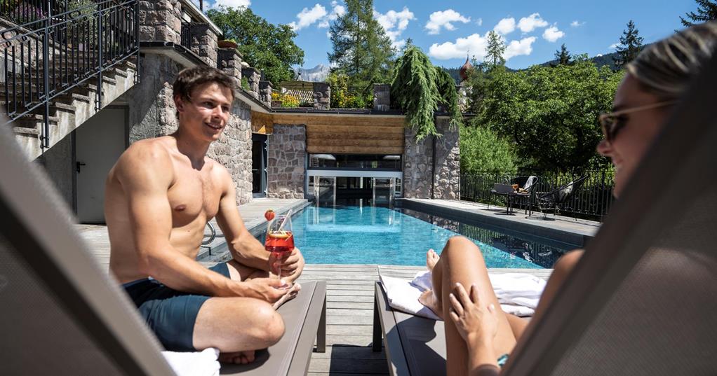 Two guests relax at the pool